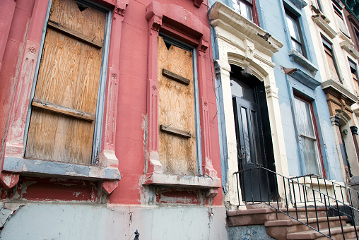 Row of boarded up houses in Harlem, New York City.