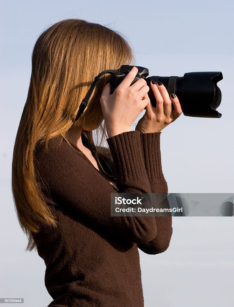 Female Photographer Female photographer in action. 20-29 Years Stock Photo