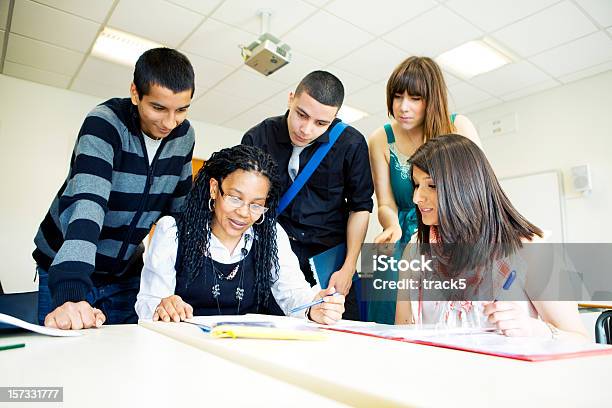 Further Education Diverse Class Tutorial With Teacher Helping Her Pupils Stock Photo - Download Image Now