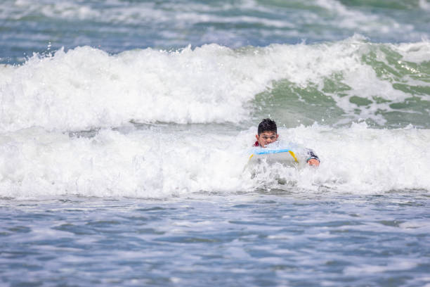 istock Boy Bodysurfing California 1573319020