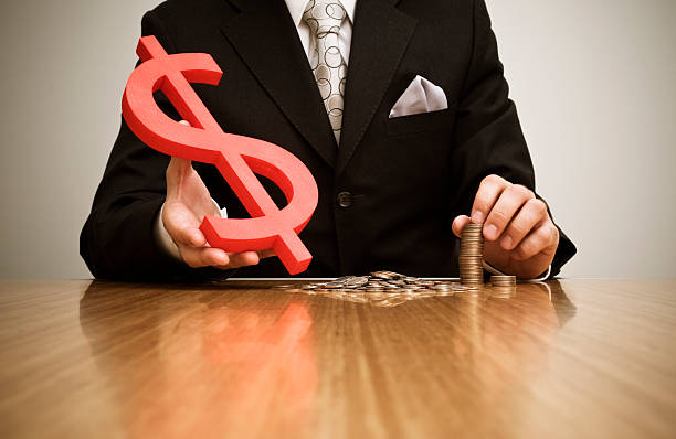 istock Businessman handing a dollar sign 157331946