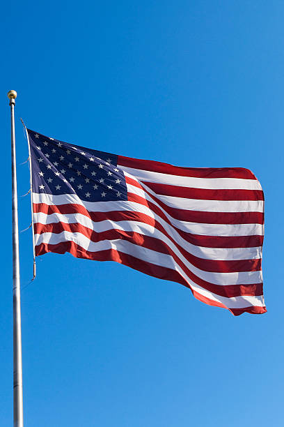 istock American Flag flying on a flagpole 157332234