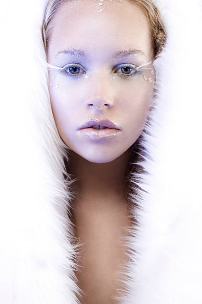 Gorgeous blond ice queen in white fur, copy space.