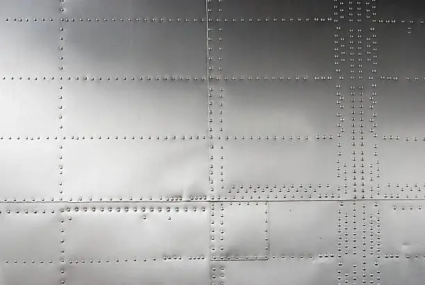 Photo of Aircraft siding with rivets, textured background