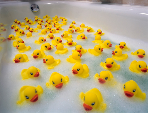 Sea of toy ducks in the bathtube