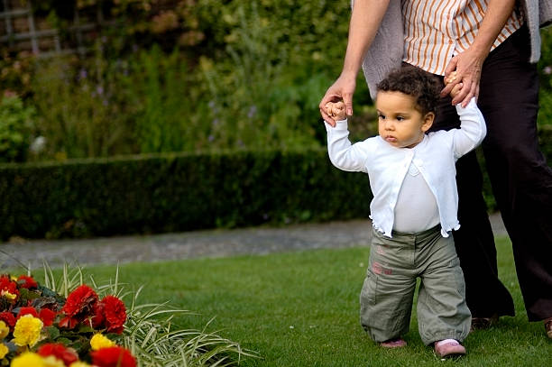 istock Granddaughter Having her First Steps in the Park 157332622
