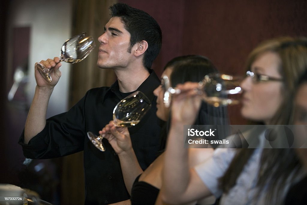 Man and women tasting different wines Friends out wine tasting. Tasting Stock Photo