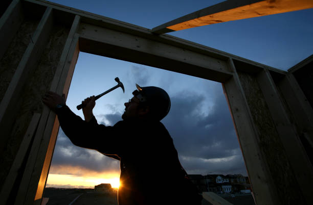 the builder tests the strength of the protective helmet