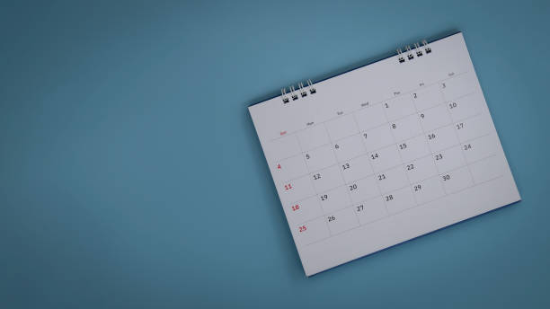 istock White calendar on blue background, planning concept 1573329301