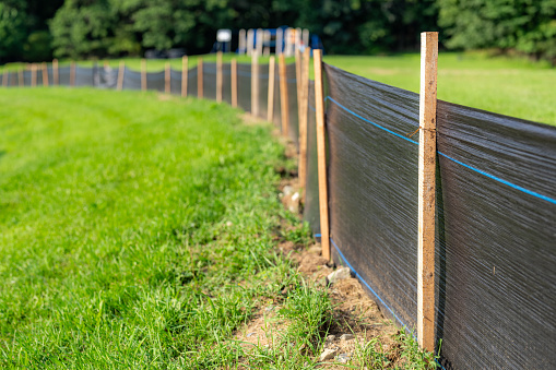 Silt Fence fabric with wooden posts installed prior to the start of construction.