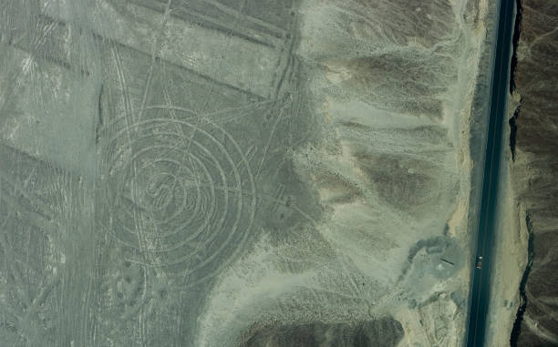 istock Circular Nazca geoglyph in desert with Pan-American Highway vehicle Peru 157333088