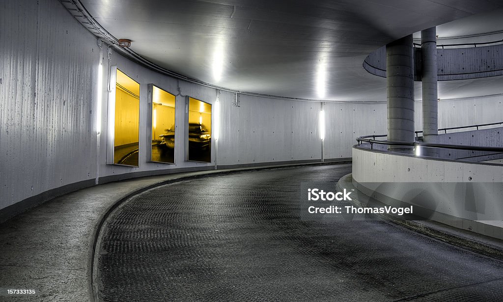Parking garage driveway Parking garage driveway with illuminated billboards. Composite (replaced original advertisements). Clipping path. Advertisement Stock Photo