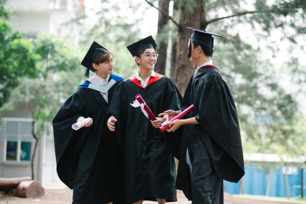 istock Happy Asian students walking in school. 1573332797