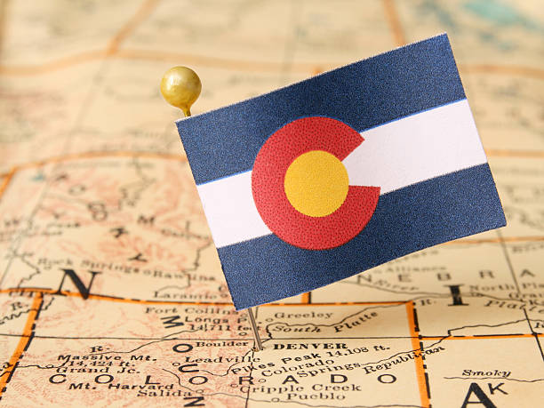 Colorado Colorado flag over more that sixty years old map pointing Denver city. Shallow depth of field attraction studio photography stock pictures, royalty-free photos & images