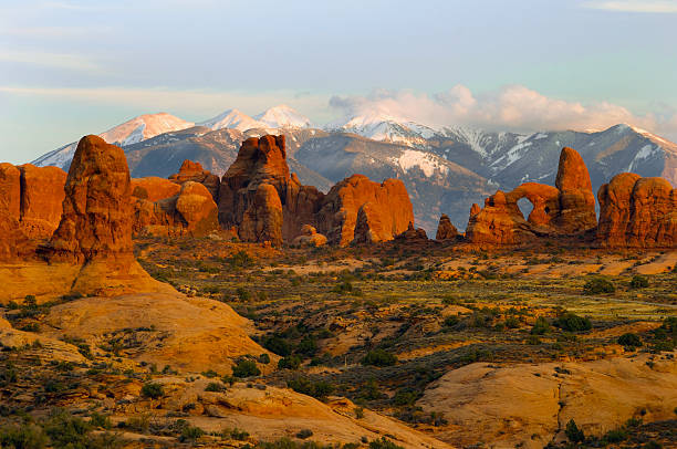 Snow capped mountains behind the red rocks of Moab Utah.
