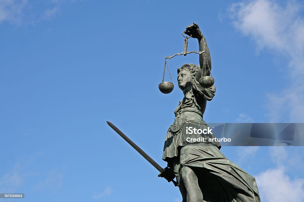 ancient Justicia statue with scale and sword from left 300 year old statue of Lady Justice overseeing the Well of Justice  at Frankfurts Roemer Square / Germany, Law Stock Photo