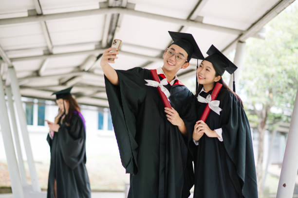 istock Happy Asia inversity student taking selfie in school after graduation. 1573338534