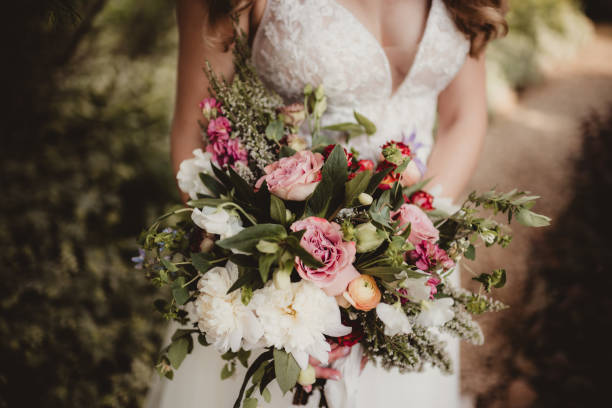 istock Bride holding bouquet of colorful floweres 1573339553