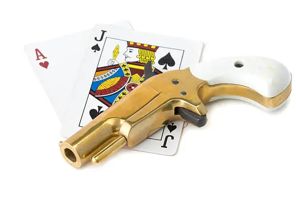 Photo of Derringer handgun and blackjack