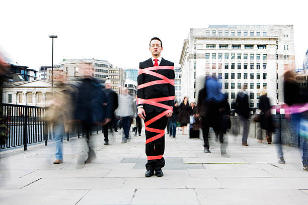 London business man tied up in bureaucracy and red tape Getting nowhere fast... in bounds stock pictures, royalty-free photos & images