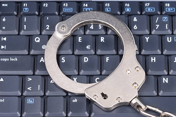 Handcuff on Keyboard stock photo