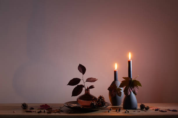 istock autumn dark decor with candles on wooden shelf on background wall 1573345252