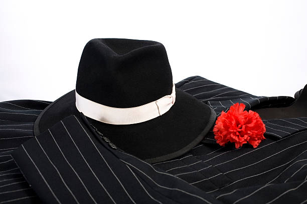 1920's style man's pinstripe suit with hat and red carnation in lapel.