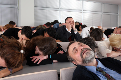 Sleeping audience at a boring business seminar