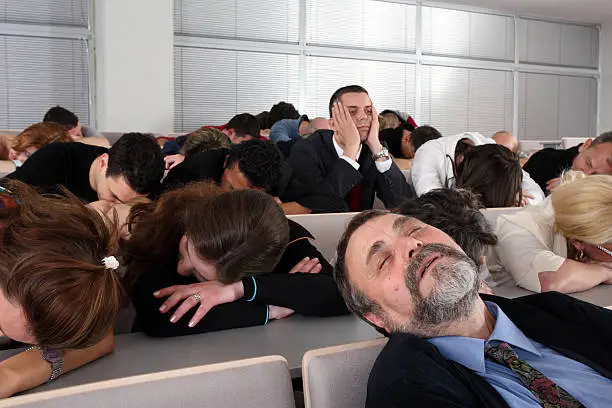 Photo of Sleeping audience at a boring business seminar
