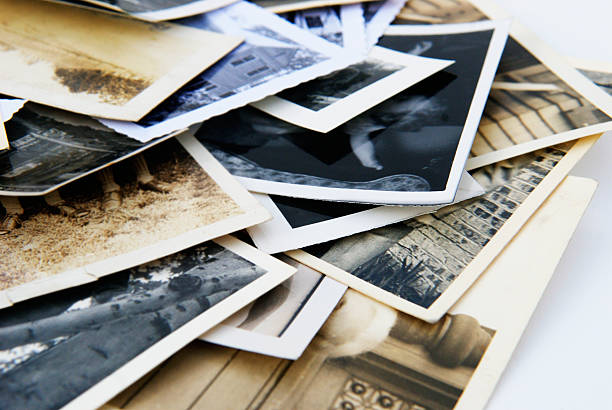 Old Vintage Retro Candid Photographs in a Pile Old vintage and retro photographs in a pile.  These could be candid snapshots with nothing recognizable in any of the photographs.   This group of photos is full of memories and sentimentality.  Uses are scrapbooking, memory problems, family history and family tree projects among many others.   reminder photos stock pictures, royalty-free photos & images