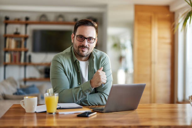 istock Young businessman working on a computer at home. 1573355245