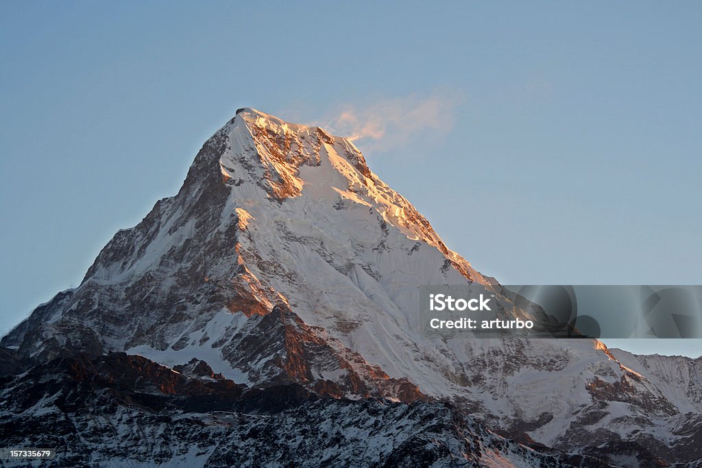 Annapurna mountain peak glowing in very first morning light Annapurna South peak at dawn Eternity Stock Photo