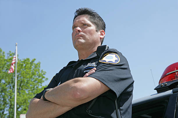 istock Police Officer Looking Away With American Flag 157336012
