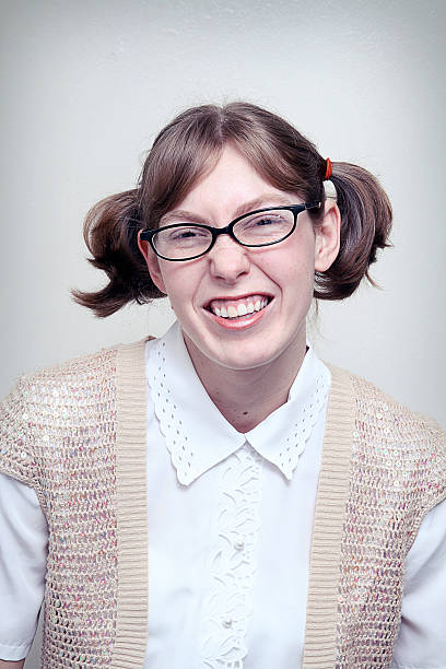 Nerd Girl Highschool Picture A nerdy young woman poses for a portrait shot.  Vertical with copy space. high school photos stock pictures, royalty-free photos & images