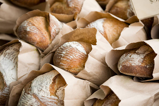 Freshly baked bread in bags at a farmers market stock photo