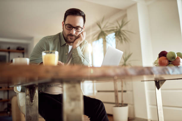 istock Young male entrepreneur working at home. 1573361381