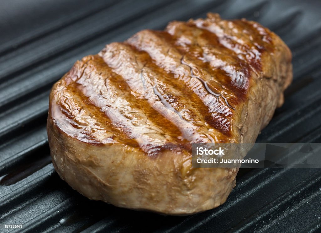 Fillet Mignon Grilled Fillet Mignon in a skillet (this picture has been shot with a High Definition Hasselblad H3D II 31 megapixels camera and 210 mm f4H  Hasselblad macro lens) Cooking Pan Stock Photo