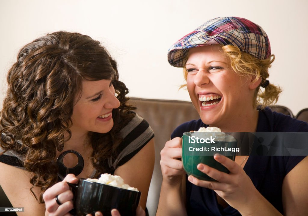 Young People in a Cafe Laughing young women in a cafe. 20-29 Years Stock Photo