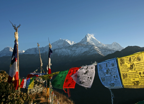 view of the Annapurna range with colourful tibetan prayer flags