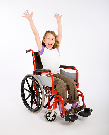 A happy child sitting in a wheelchair.