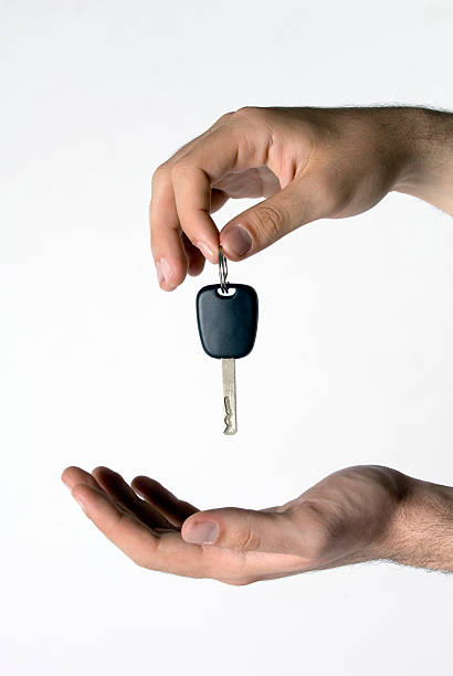 istock Man putting keys into man's hand, close-up of hands 157336749