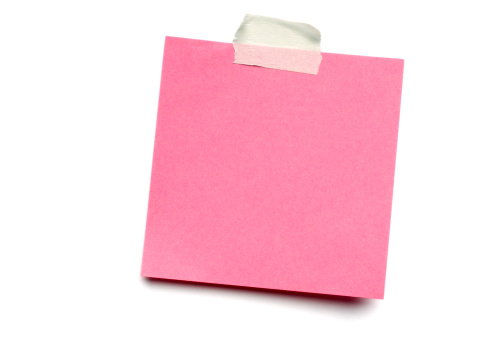 Blank pink post-it note isolated on white