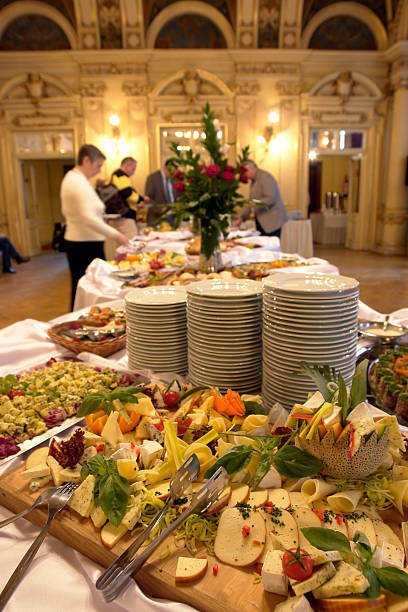 Catering, banquet, a large selection of snacks on plates, old theater interior. People in the background.