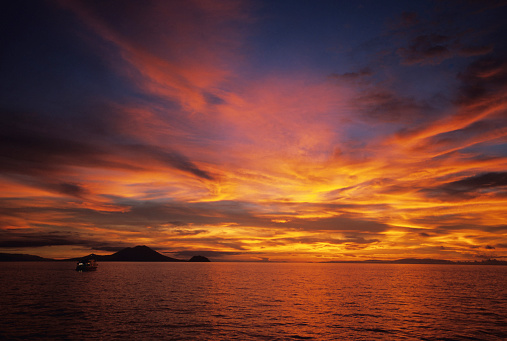 The beautiful warm hues in the sky above a ocean horizon