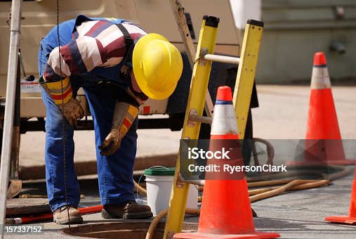 istock Construction Worker Looking Down man hole. 157337152