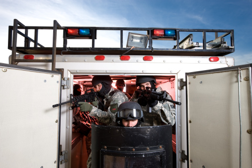 SWAT Team Exiting Transport Vehicle With Riot Gear