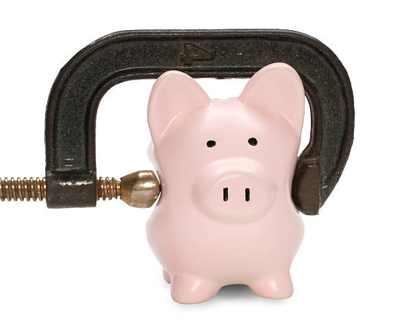 istock Piggy bank w/squeezing C clamp&clipping path 157337361