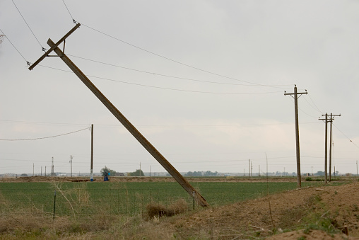 On May 22, 2008 a F3 tornado twisted and snapped power lines as well as destroyed many homes in Greeley, Colorado. This set of leaning telephone pole lines survived along a dirt, county road along agricultural farms and fields just outside of town.