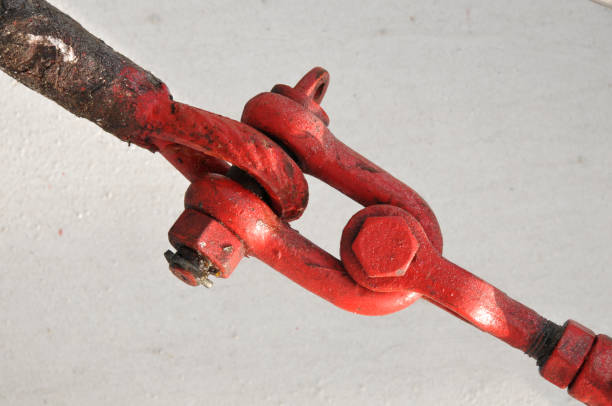 Red painted cable on ship fastened in turnbuckle or rigging screw.