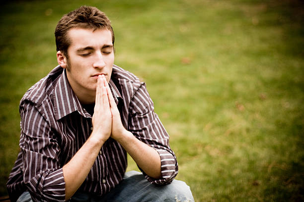 male looks up in prayer.
